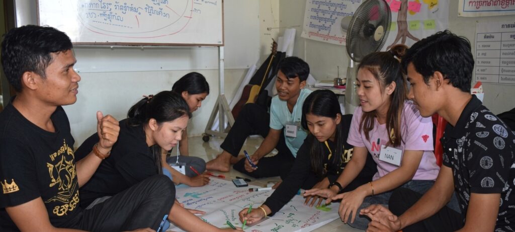 Participants hover together to create poster