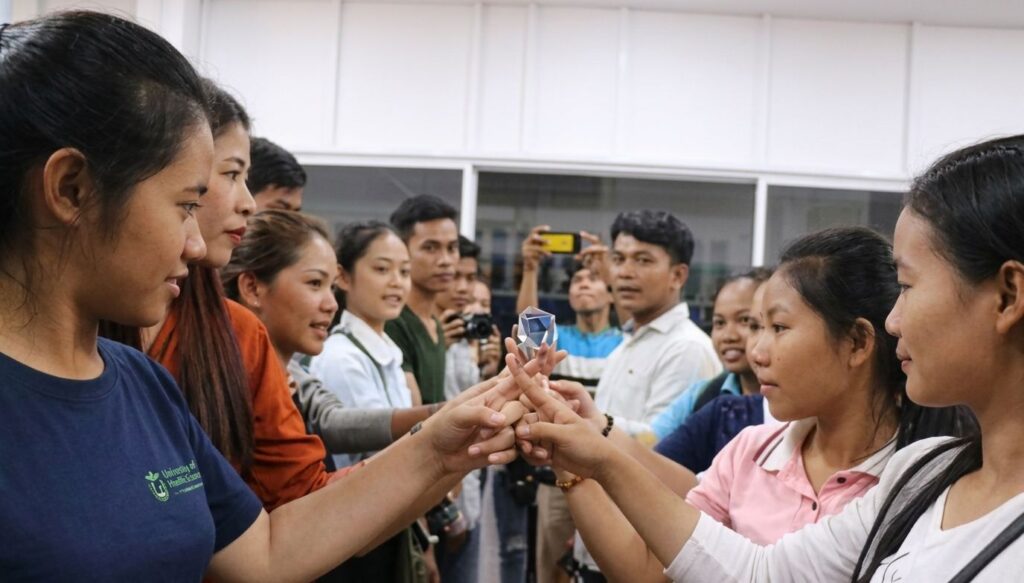 Participants gaze into a crystal object